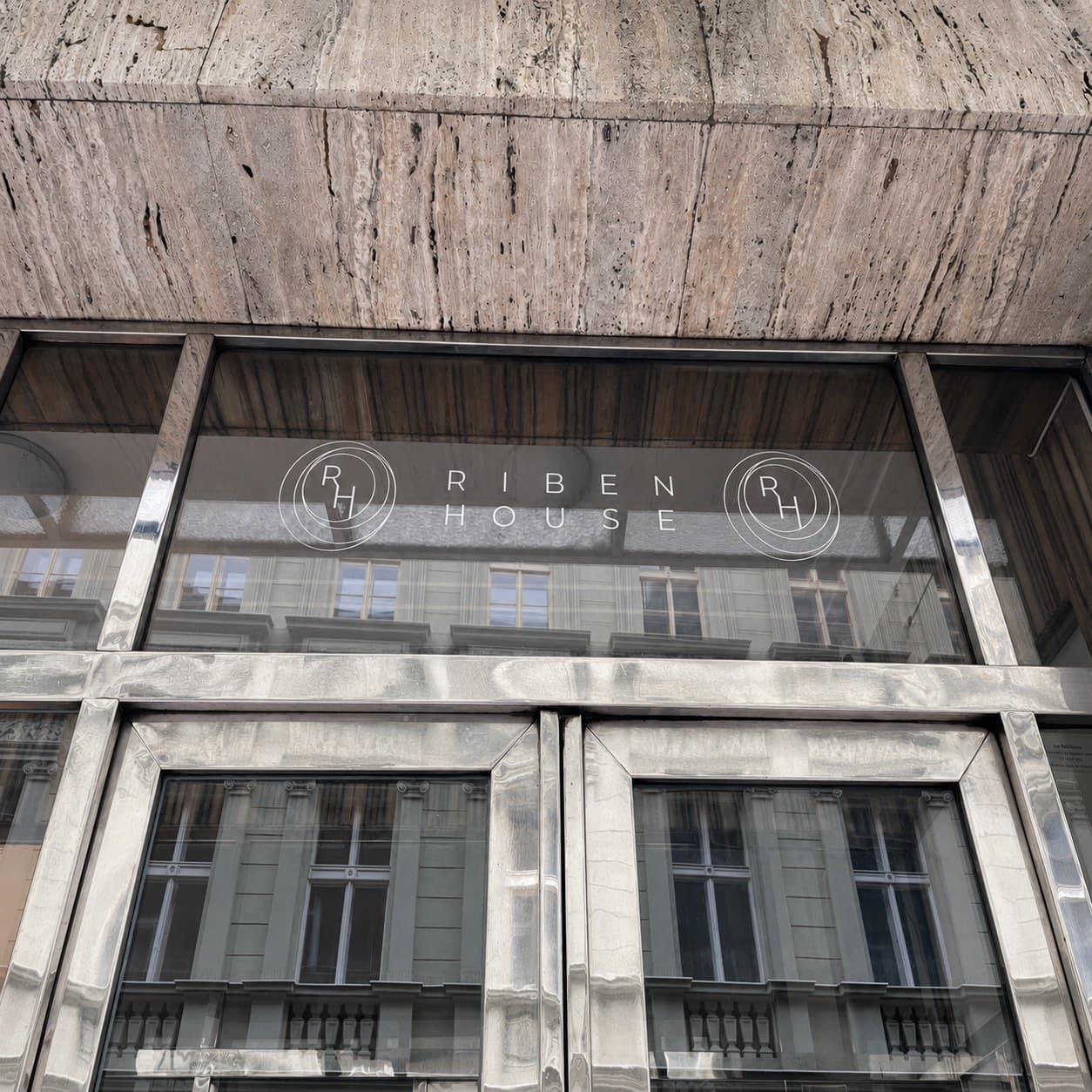 Řezaná samolepka s logem RIBEN HOUSE na skle nad vchodovými dveřmi